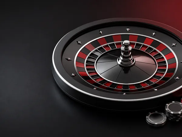 Decorative black and red roulette wheel with gaming chips