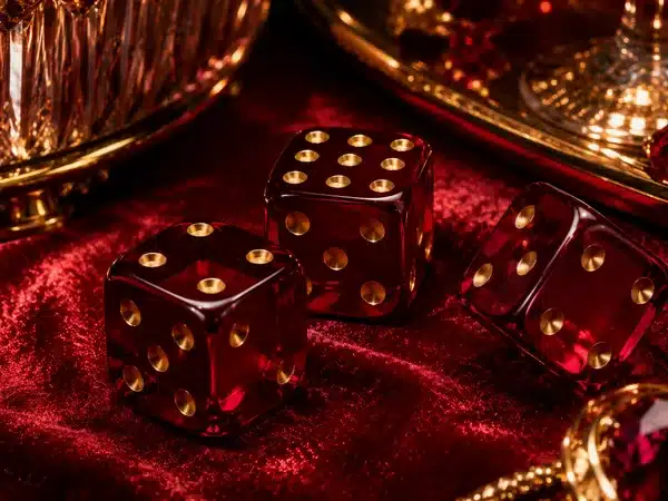 Decorative translucent red dice on red velvet
